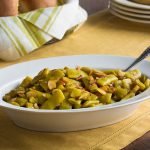 White Serving Dish of Green Beans Almondine on a Dinner Table