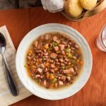 Top view of Southern-Style Black Eyed Peas and Ham Soup in a White Bowl