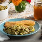 Lemon Dilly Beans with Breaded Fish and a Lemon Wedge on a Blue Plate