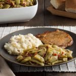 Southern Style Green Beans with Mashed Potatoes and Pork Chop on a Dinner Plate